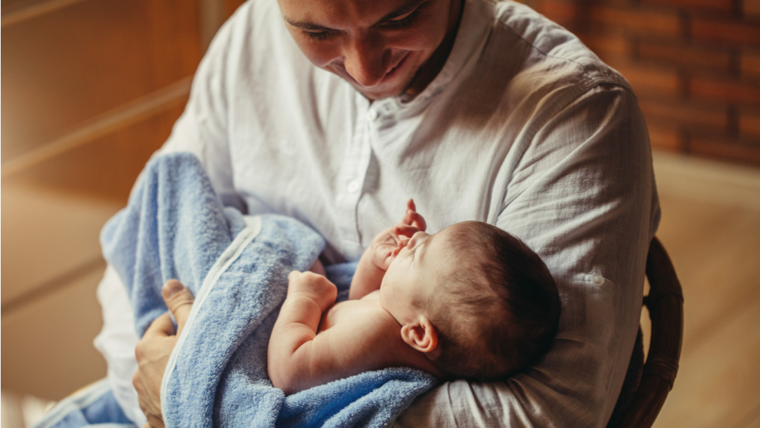 Man holding new born baby