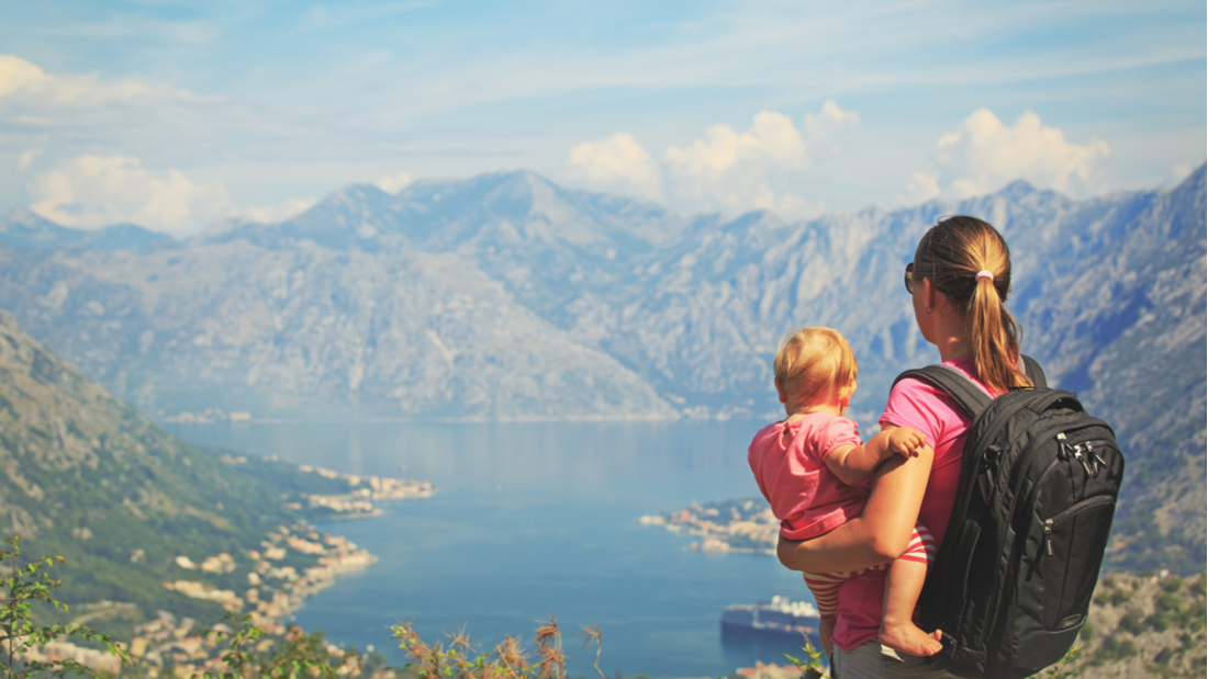Mother and baby looking at a mountain view