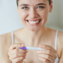 woman with pregnancy test, yes or no?